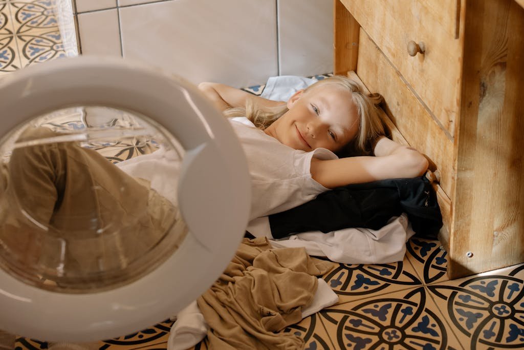 Girl Smiling while Lying on the Floor