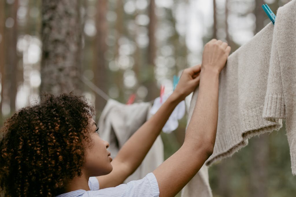 Woman Hanging her Clothes